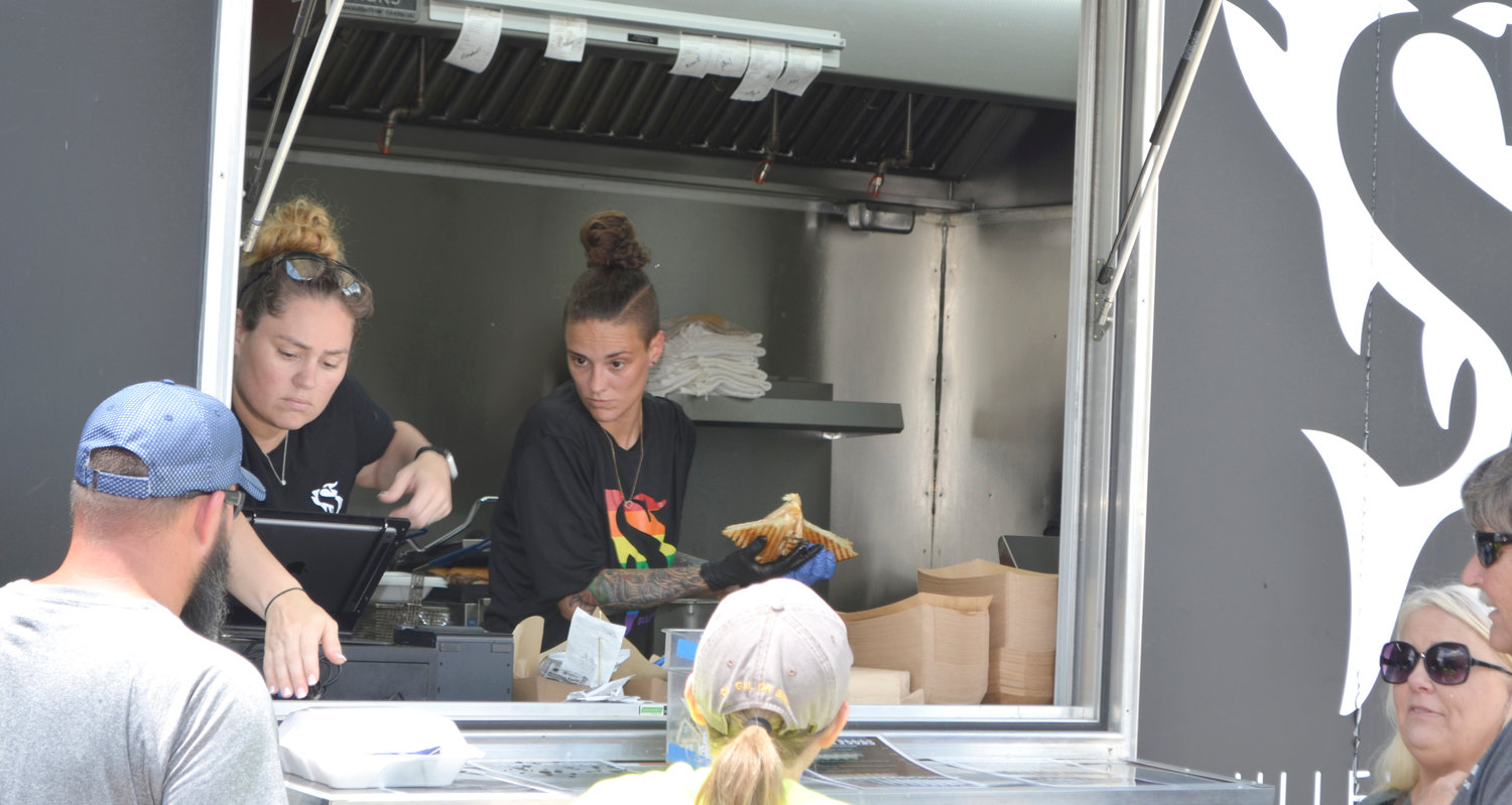 Chef Jordan Savell, right, and her crew reported record sales Saturday when they set up the Bullfish Foods trailer at The Pecan House in Mineola with her menu of custom sandwiches.